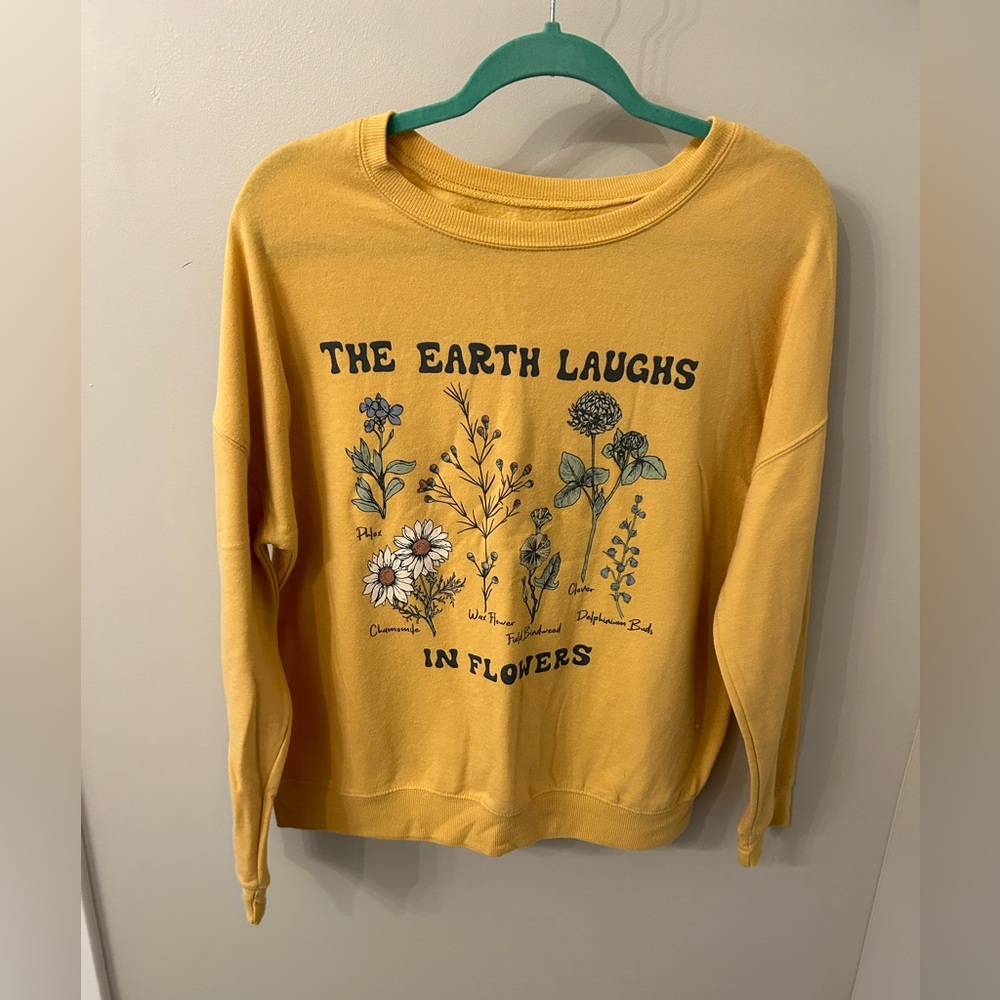 Size large for women. “The earth laughs in flowers”